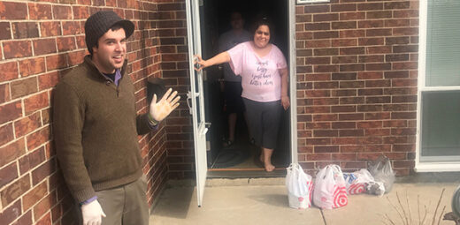 staff delivering food to resident